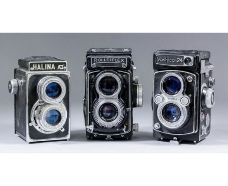 A Rolleiflex medium format twin lens camera by Franke & Heidecke, with F3.5 Carl Zeiss lens, together with four other cameras