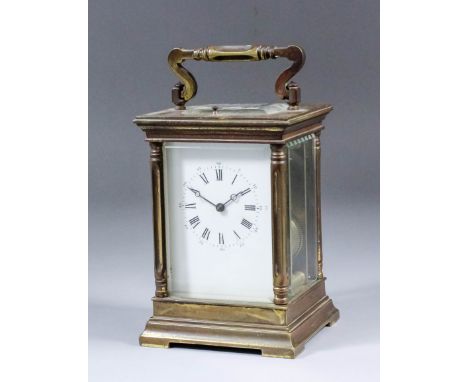 An early 20th Century brass cased carriage clock, the cream enamel dial with Roman and Arabic numerals, to the eight day two 
