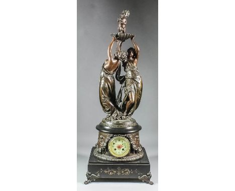 A late 19th Century French bronzed spelter mantel clock, the 3.5ins diameter porcelain dial with floral ornament, to the eigh