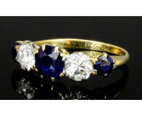 A 20th Century yellow coloured metal mounted sapphire and diamond five stone ring, the three circular cut sapphires of approx