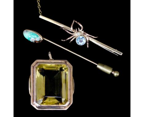 A 9ct gold fronted bar brooch with spider to front, the body set with a pale blue stone and seed pearl, 2.5ins overall, a gol