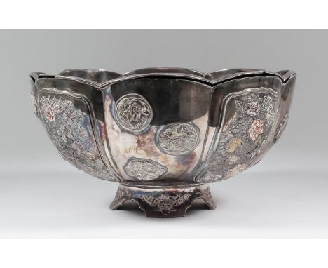 A Chinese white metal and enamel circular bowl of panelled form with shaped rim, the exterior with four panels embossed and e