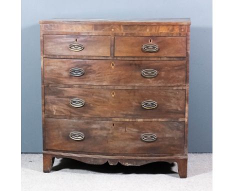 A late Georgian mahogany bow front chest with reeded edge to top and frieze inlaid with stringings, fitted two short and thre