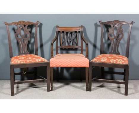 A pair of mahogany dining chairs of country Chippendale design with shaped crest rails, fretted splats, drop in seat upholste