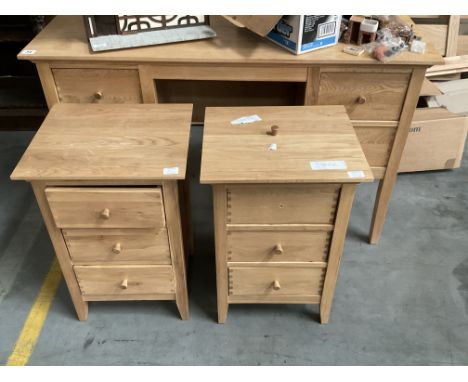 An light wood bedroom suite comprising 2 bedside cabinets, Dressing table, Double bed frame and slats.