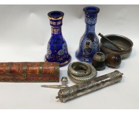 A collection of Middle Eastern items a white metal scroll case pipe bangles and two blue glass enamel decorated bottle vases.