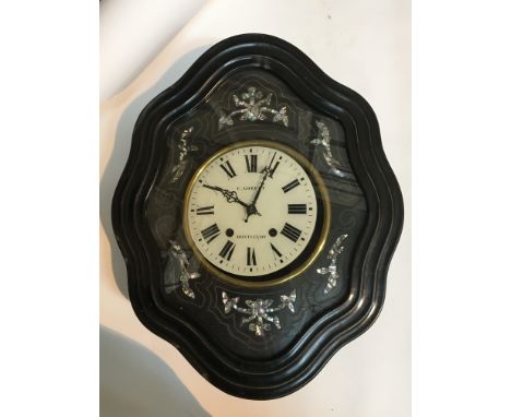 A Continental late 19th century wall clock the case with mother of pearl decoration maker E Gobetrt Montucon. Case size 62x51