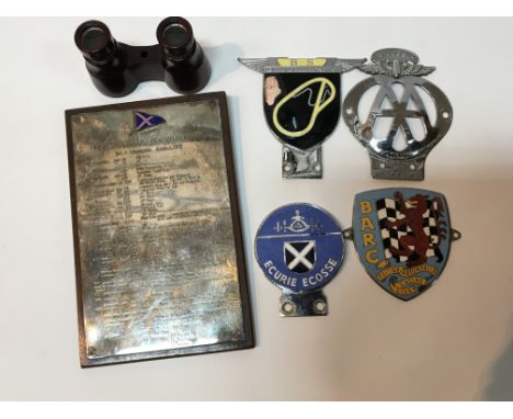 A collection of vintage car badges a Rhodesia AA badge B-S Brooklands badge and a Lymington 1910 plaque engraved with a list 