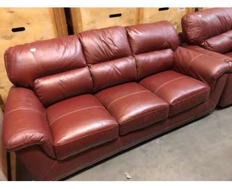 A good quality red leather three seater sofa and matching arm chair (2)