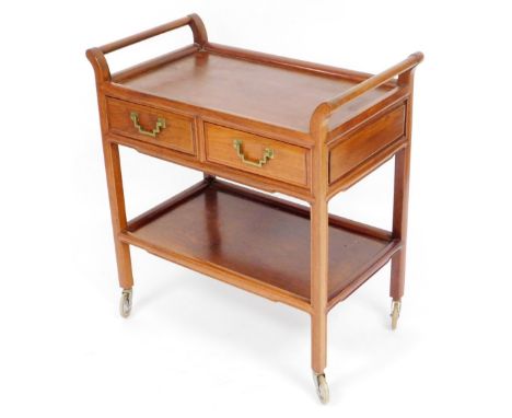 A Chinese hardwood two tier tea trolley, the top with two drawers with brass handles, on single shelf base, with castors, 80c