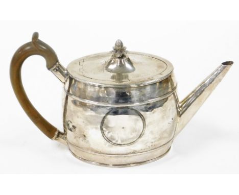 A William IV oval silver teapot, with acorn finial top with circular vacant crest, London 1832, 15oz gross. 