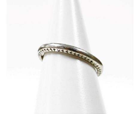 A platinum wedding band,  of etched design to the sides but worn and mis-shapen, ring size K, 4.4g all in, boxed.