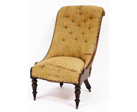 A spoon back nursing chair, with oak frame and button back floral upholstery, with ribbon borders on castors, 102cm high, 55c