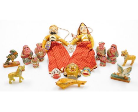 An Tibetan Tihanki carved puppet duo, together with various carved animal figures. 