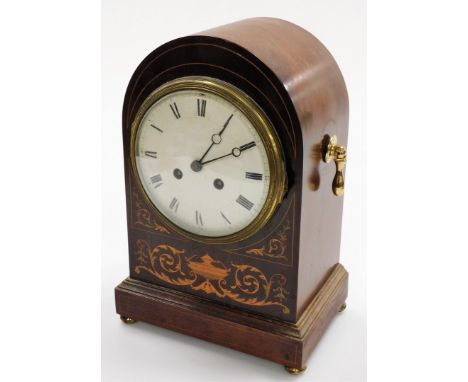 A Sheraton Revival mahogany marquetry domed mantel clock, the case with inlays of urn and scrolls, with a white enamel dial, 