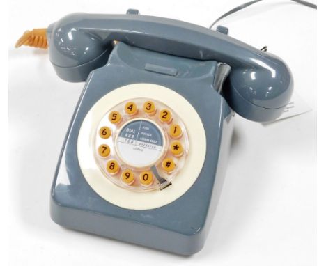 A push dial button modern telephone, in the vintage style, grey with orange buttons.