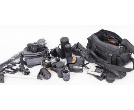 A group of various camera equipment, comprising tripods, Pentax 330, Pentax ME Super Hoya 80-205mm lens, flashes and exposure