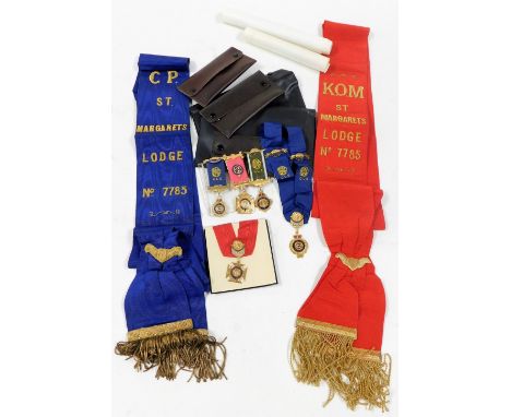 A group of Masonic memorabilia, comprising two induction certificates, red medal and sash, blue sash and medal, and three med