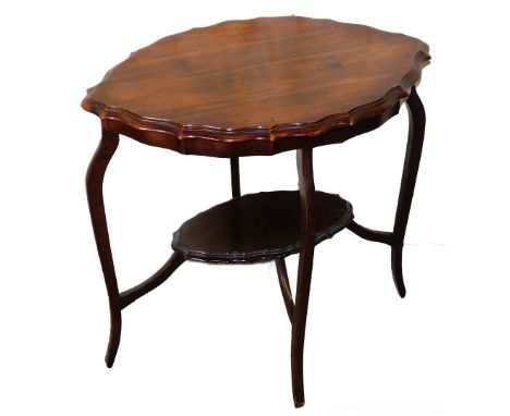 A Victorian walnut occasional table, with lozenge shaped top with piecrust border and under shelf, on splayed legs, 71cm high