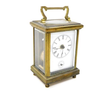A late 19thC brass carriage clock, with white enamel dial and seconds dial, key wind 11cm high.