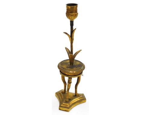 A 19thC French ormolu candlestick, gilt decorated with a palm leaf stem, on a circular console table base, each leg depicting