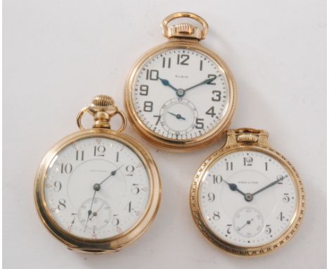 Three American gold plated open faced crown wind pocket watches to include a Waltham, a Hamilton and an Elgin, the latter a r