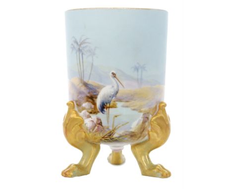An early 20th Century Royal Worcester vase, the beaker body raised to three gilt claw feet and decorated by Walter Powell wit