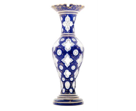 A late 19th Century Moser glass vase the stepped foot below the inverted baluster body rising to the slender flared neck with