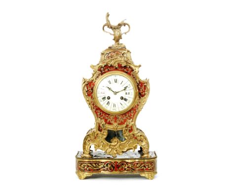 A late 19th Century French red tortoiseshell boulle work mantle clock the circular dial enclosed by a bezel door wityh an gil