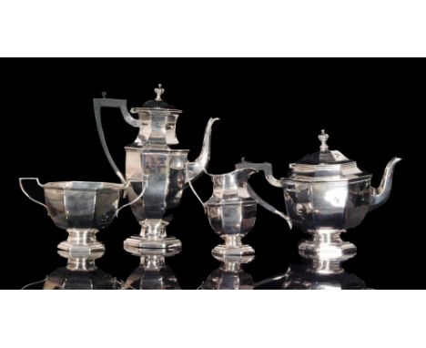 A hallmarked silver four piece tea service composed of teapot, twin handled sugar bowl, cream jug and hot water, each of octa