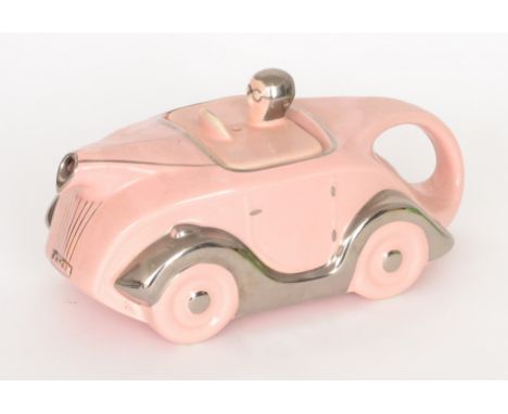 A 1930s Sadler teapot modelled as a pale pink racing car with silver lustre trims, detailing and OKT42 number plate, Sadler s