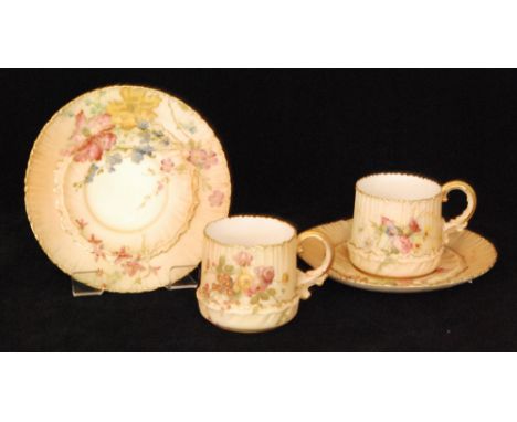 Two early 20th Century Royal Worcester blush ivory cups and saucers, shape 1682, each decorated with meadow flowers and folia