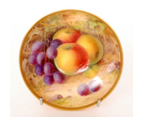 A Royal Worcester Fallen Fruits footed bowl decorated by A. Shuck with hand painted apples and black grapes, signed, puce mar