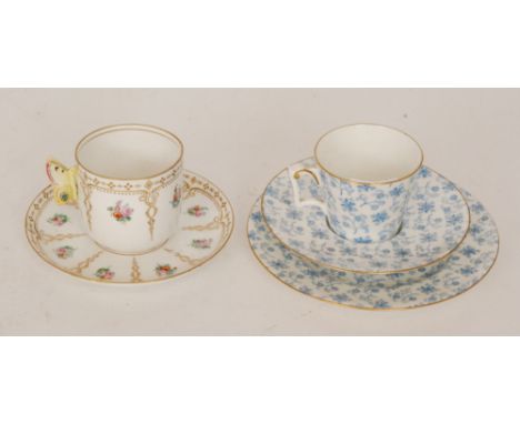 A late 19th Century Royal Worcester cabinet cup and saucer decorated with hand painted floral sprays between a gilt pattern b