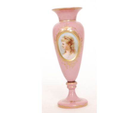 A late 19th Century French opaline glass vase the conical foot below the inverted baluster body and everted rim decorated wit