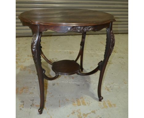 An Edwardian mahogany scalloped edge occasional table, with foliate carved apron and four cabriole legs, united by a stretche