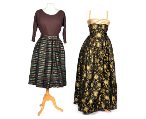 A 1950s lady's vintage full length netted evening gown in a black and gold brocade fabric with a leaf design, the bodice and 