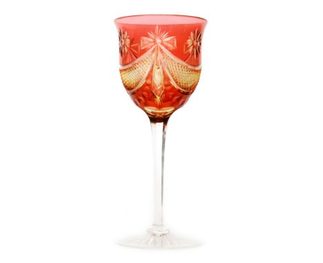 An early 20th Century Stevens & Williams hock glass the clear crystal foot below the faceted stem rising to the cased tulip b