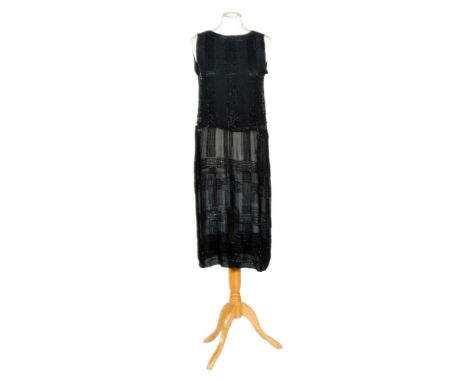 A 1920s lady's vintage cocktail dress, the black chiffon with vertical beadwork panels to the bodice and a cross hatch beadwo