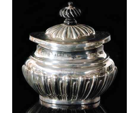 A hallmarked silver tea caddy of oval form with part fluted border and hinged cover, weight 3.9oz, marks rubbed, possibly Bir