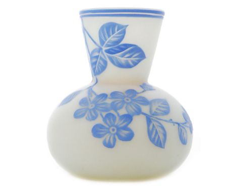 A late 19th Century Harrach cameo glass vase of globe and flared shaft form case in blue over opal and cut with a flowering b