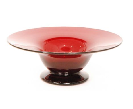 A large 20th Century glass footed bowl, the cushion foot rising to the tapered bowl and wide flared all in a deep ruby, unmar