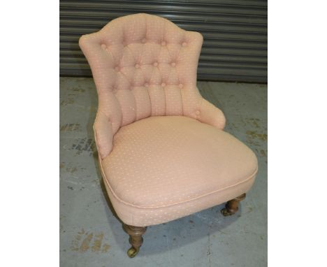 A Victorian button back easy chair upholstered in pink fabric 