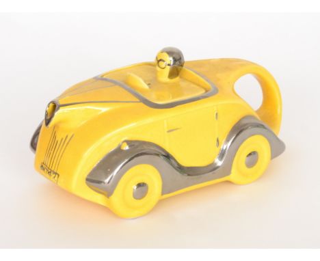 A 1930s Sadler  teapot modelled as a yellow racing car with silver lustre trims, detailing and OKT42 number plate, impressed 