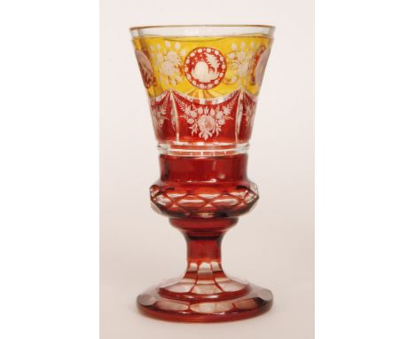 A late 19th Century Bohemian footed chalice vase the stepped foot below a faceted band rising to the flared bowls enamelled i