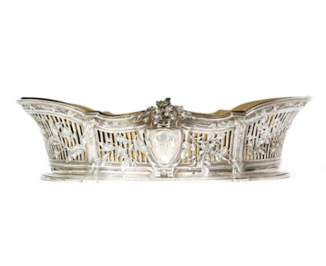 A French silver oval jardiniere or table centre piece of shaped outline with floral and foliate decoration over a pierced bas