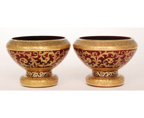 A pair of late 19th Century Bohemian glass bowls of footed tapered form decorated with gilt bands and rococo scrolls over the