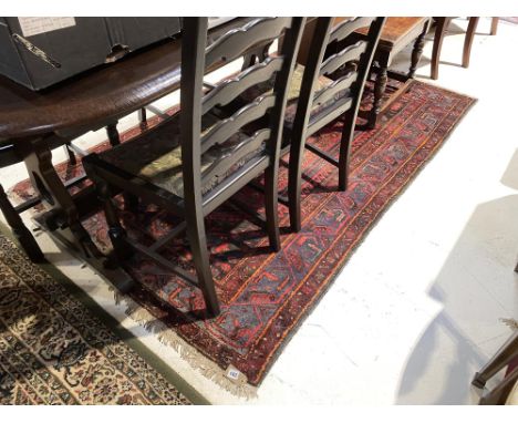 A modern carpet square, on green ground and a Persian design rug