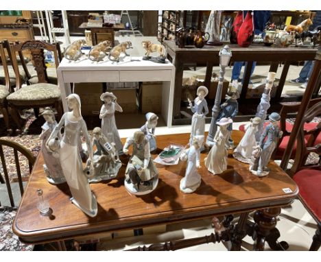 A collection of Lladro and Nao figures