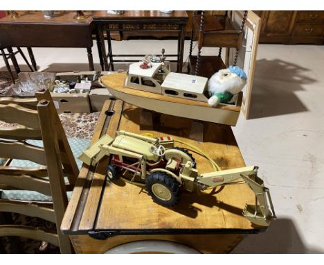 A battery operated Ford 4040 Industrial tractor and a model boat